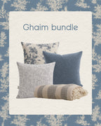 Ghaim bundle of pillows and a blanket on a decorative background