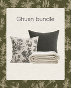 Ghusn bundle with two pillows and a blanket on a decorative background